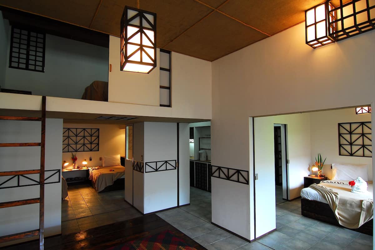 A traditional Japanese-style room with tatami flooring, shoji screens, and a low ceiling.