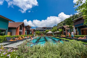 A pool area with lounge chairs and a clear blue sky. - Chaokoh Phi Phi Hotel & Resort (Ko Phi Phi)