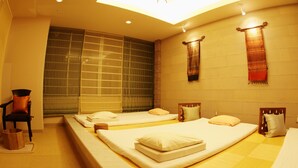 A hotel room with two beds, a large window, and a wall-mounted towel rack. - Capsule Hotel Wellbe Sakae - Caters to Men (Nagoya)