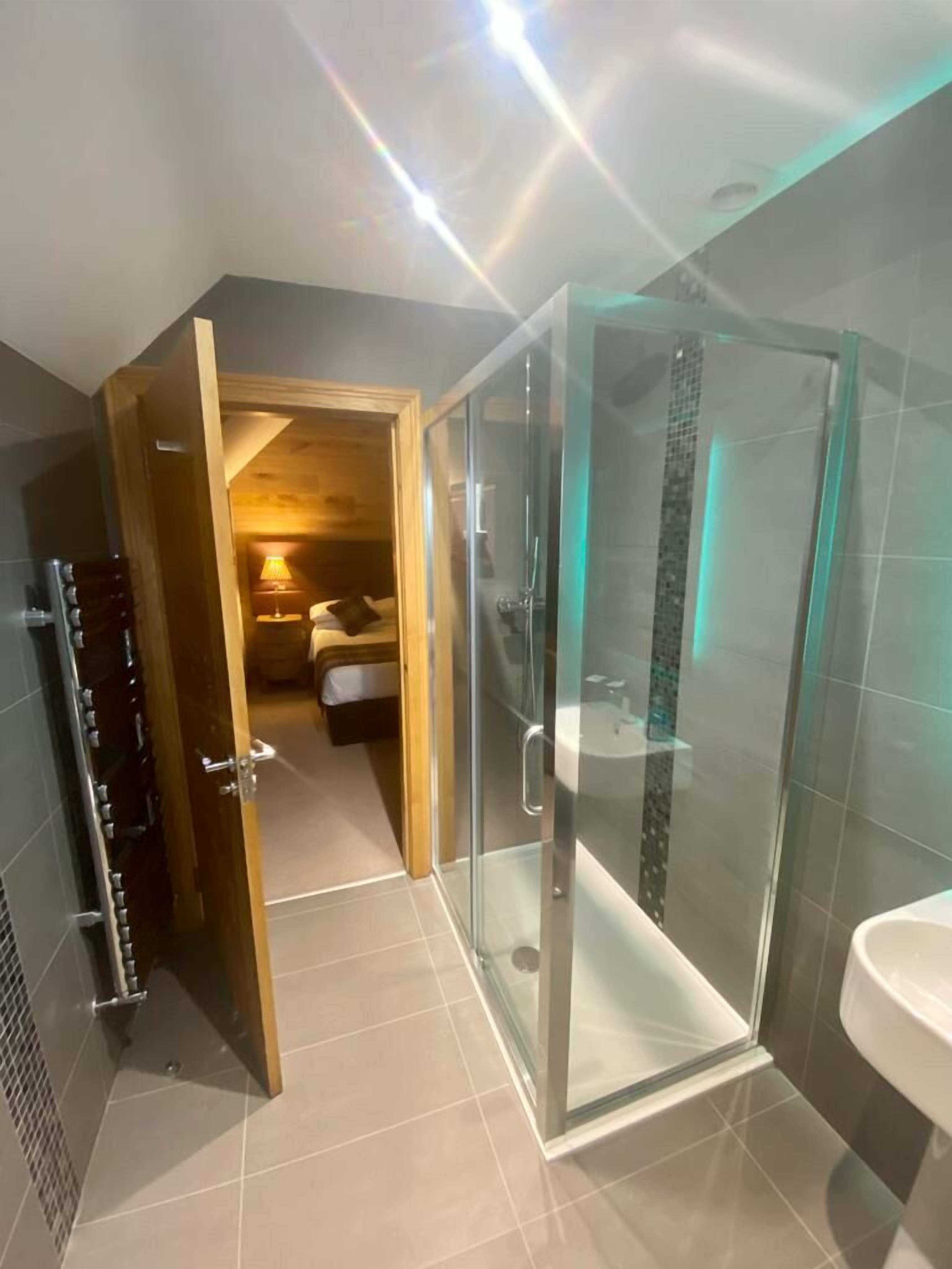 deluxe quadruple room | bathroom | shower, free toiletries, hair dryer, towels