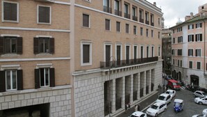 A multi-story building with a uniform facade, large windows, and balconies. - Relais Rione Ponte (Rome)