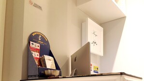 A desk with a computer, a map, and a folder. - Residenza Vatican Suite (Rome)