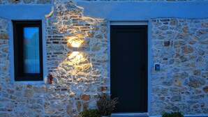 A stone building with a dark door and a window with blinds. - Guverna New City Accommodation (Zadar)