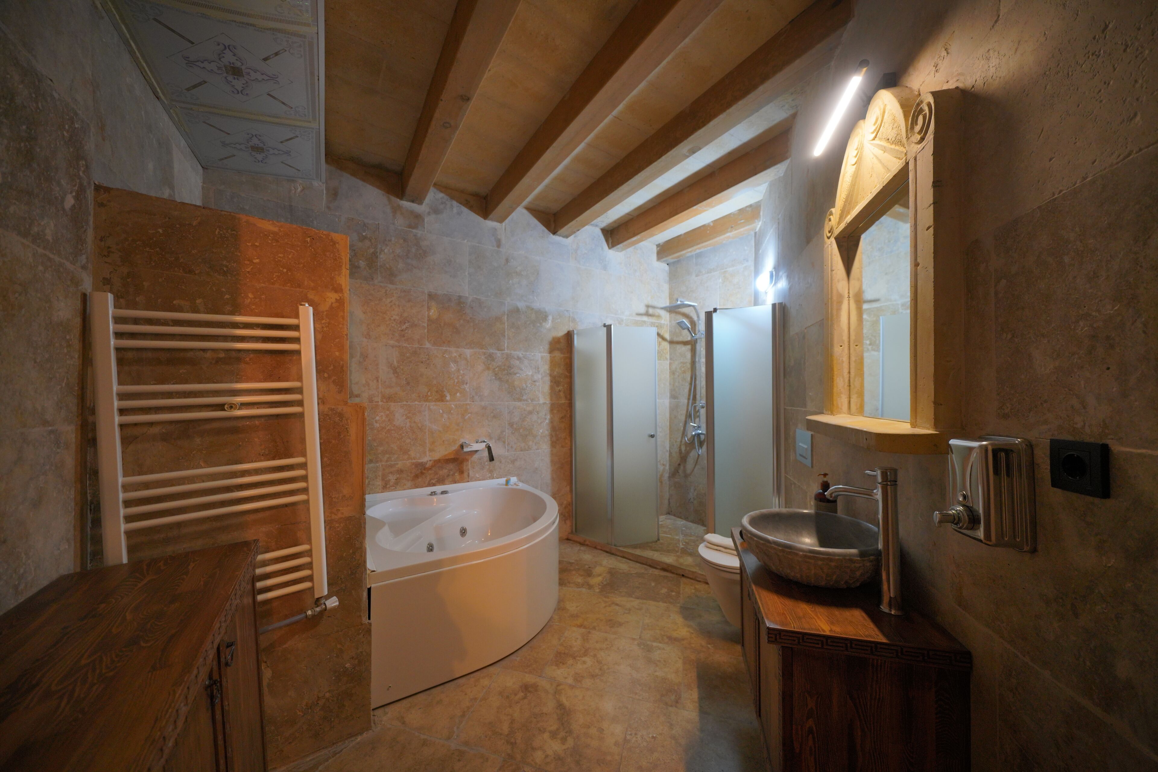 A modern bathroom with a freestanding bathtub, a glass-enclosed shower, and a vanity with a sink.