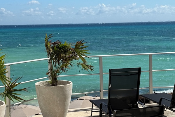 On the beach, white sand, sun loungers, beach umbrellas