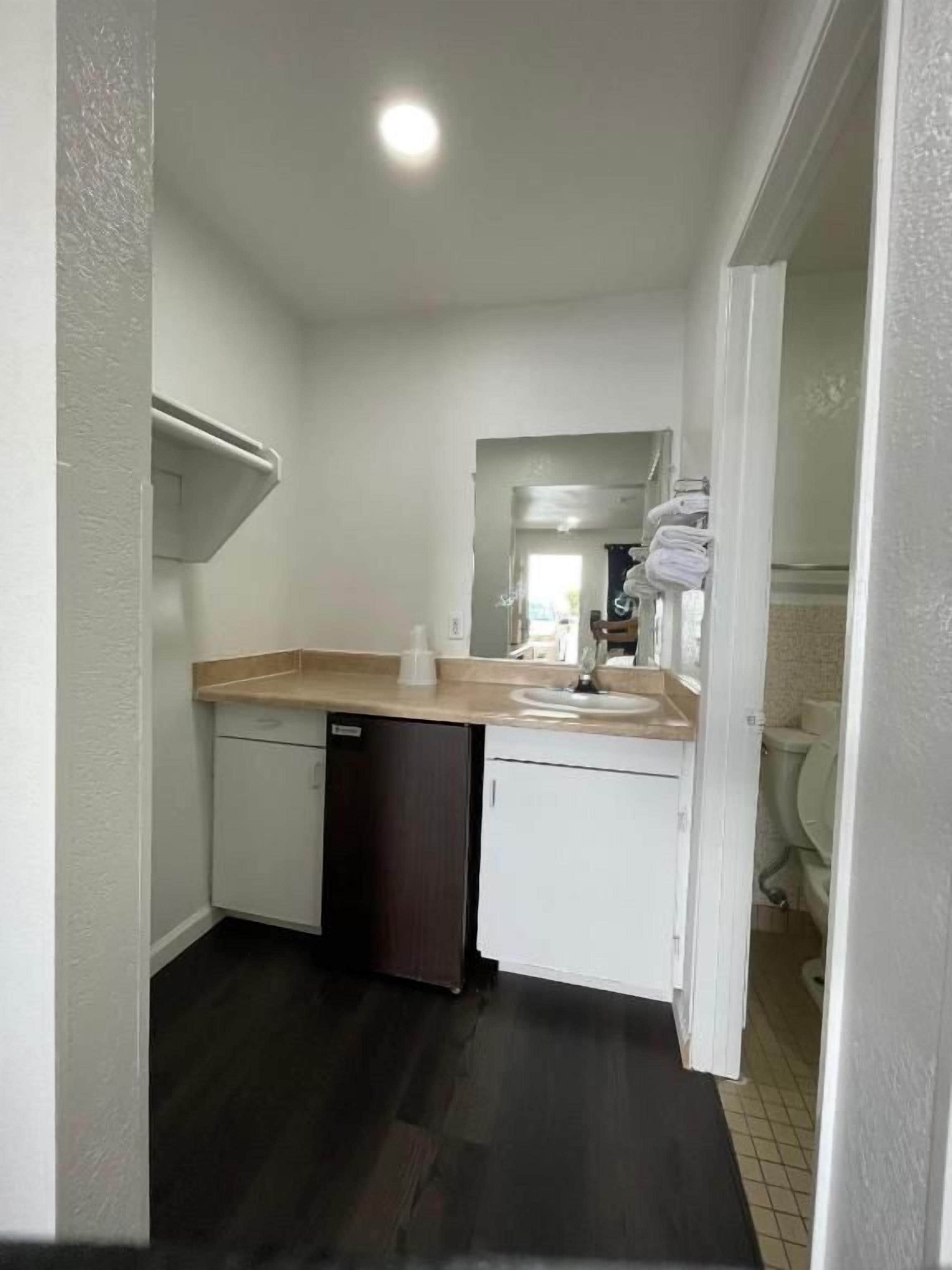 A compact kitchen with a dishwasher, a countertop, and a sink.