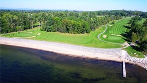 A golf course with a beach and forested area. - Bluff Point Golf Resort (Plattsburgh)