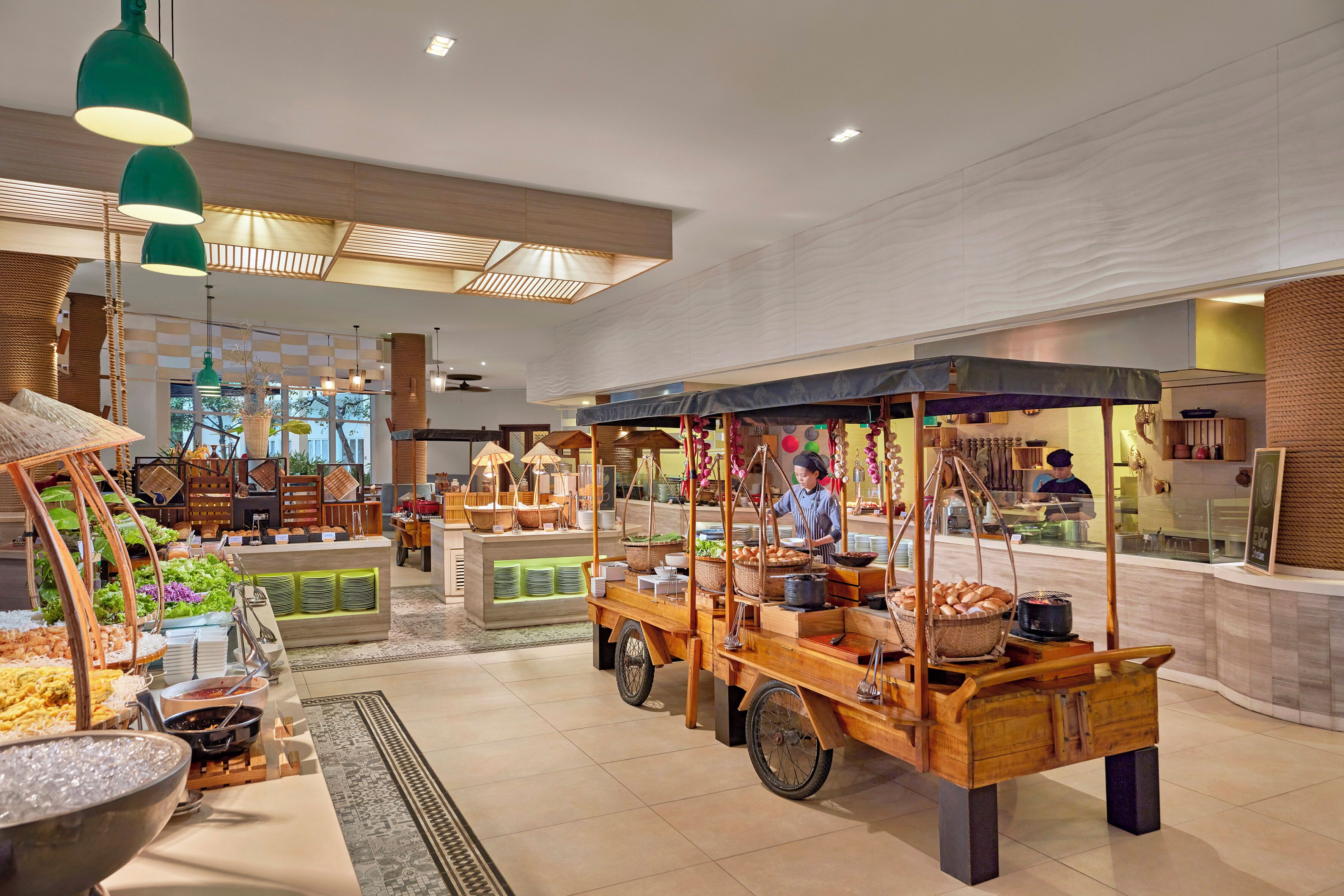 A buffet area with food stations, a seating area, and a kitchen in the background.
