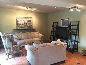 Patio Suite, 1 King Bed and 1 Queen Bed, Fireplace, Kitchenette | Living area | Flat-screen TV