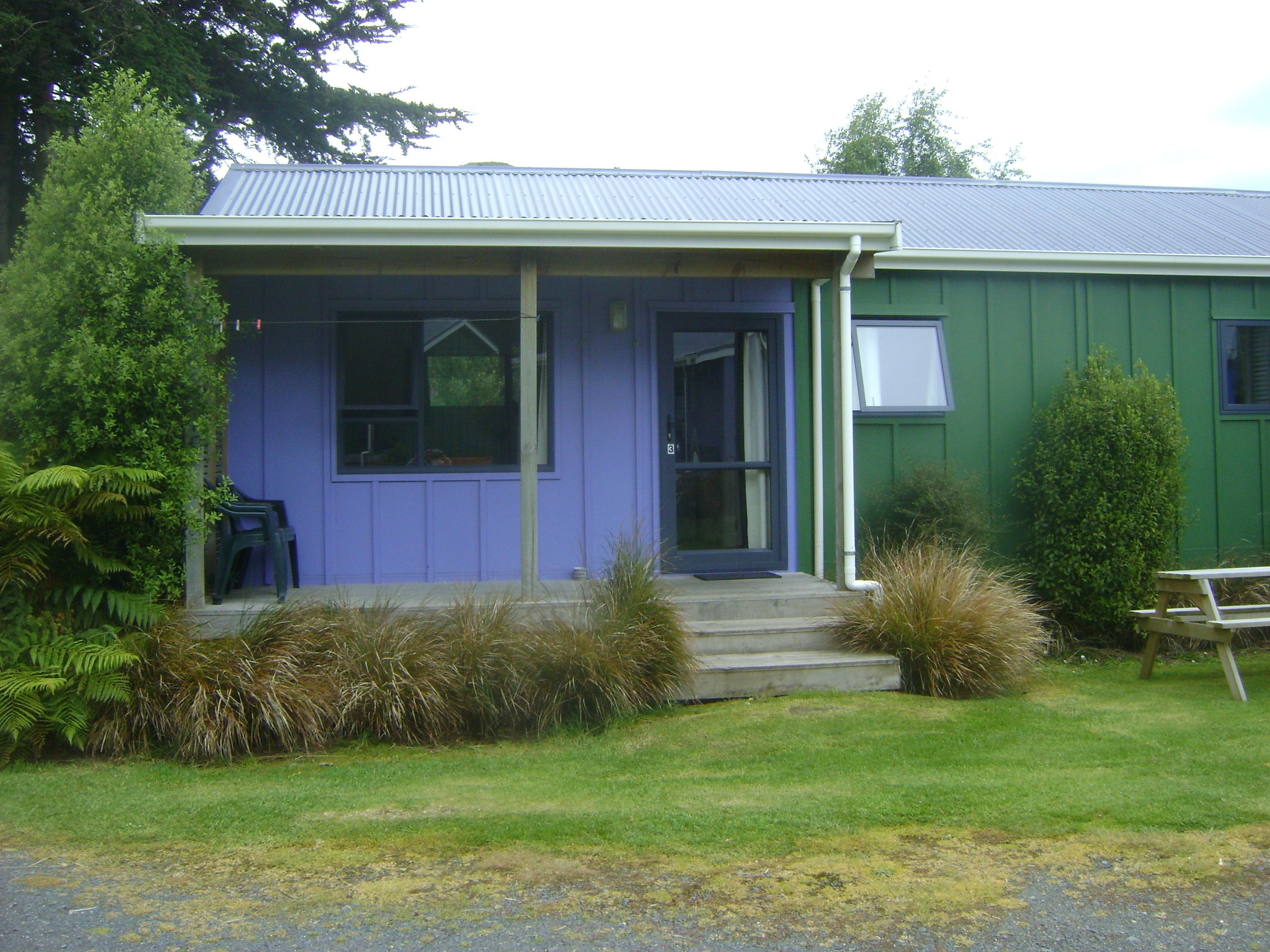 A house with a front porch, a door, and a window.