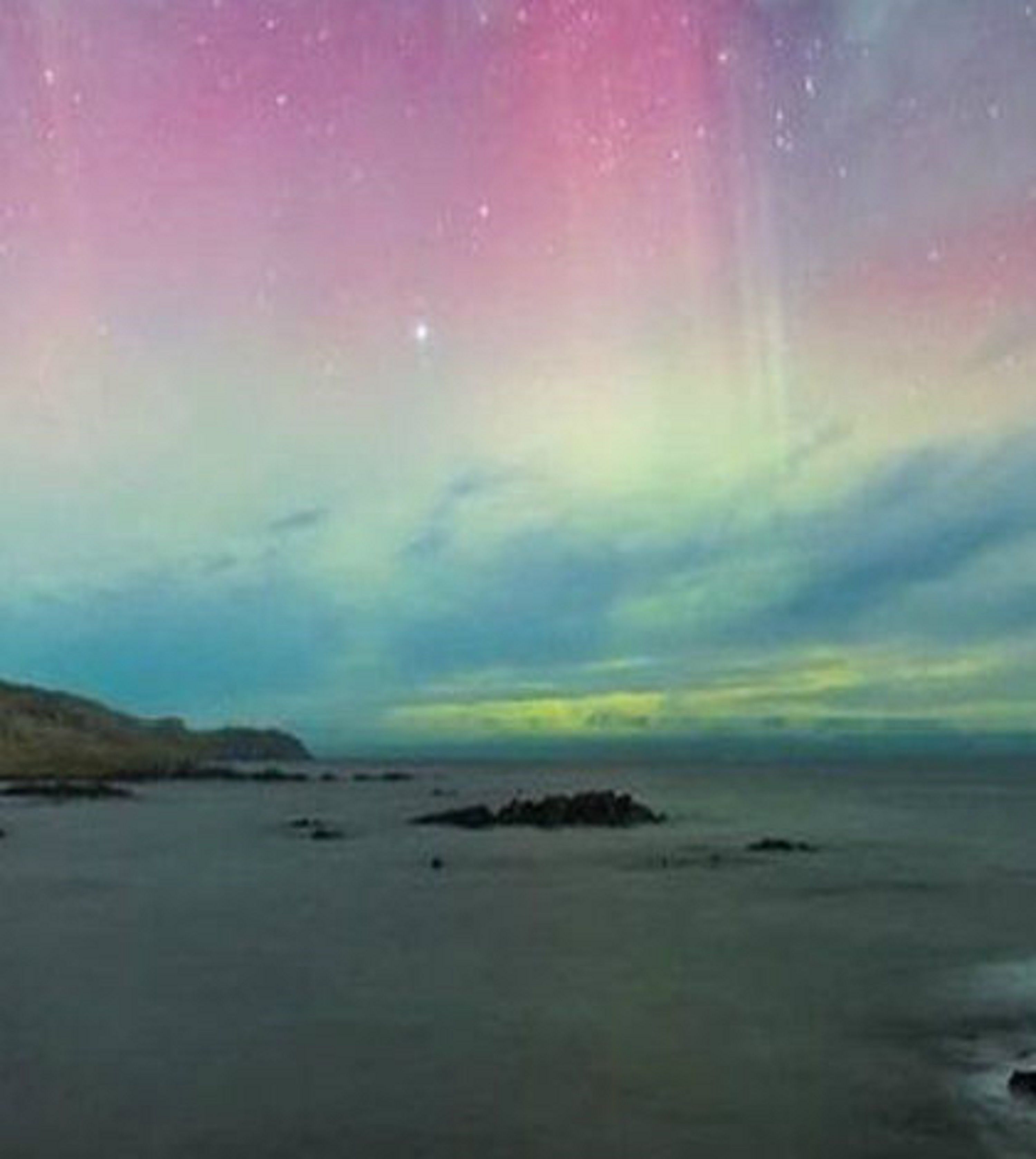A coastal landscape with a visible starry sky and a calm sea.