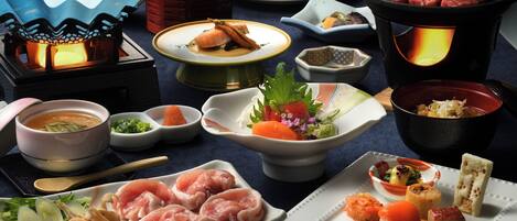 A variety of Japanese dishes, including sushi and sashimi, served on different plates and bowls.