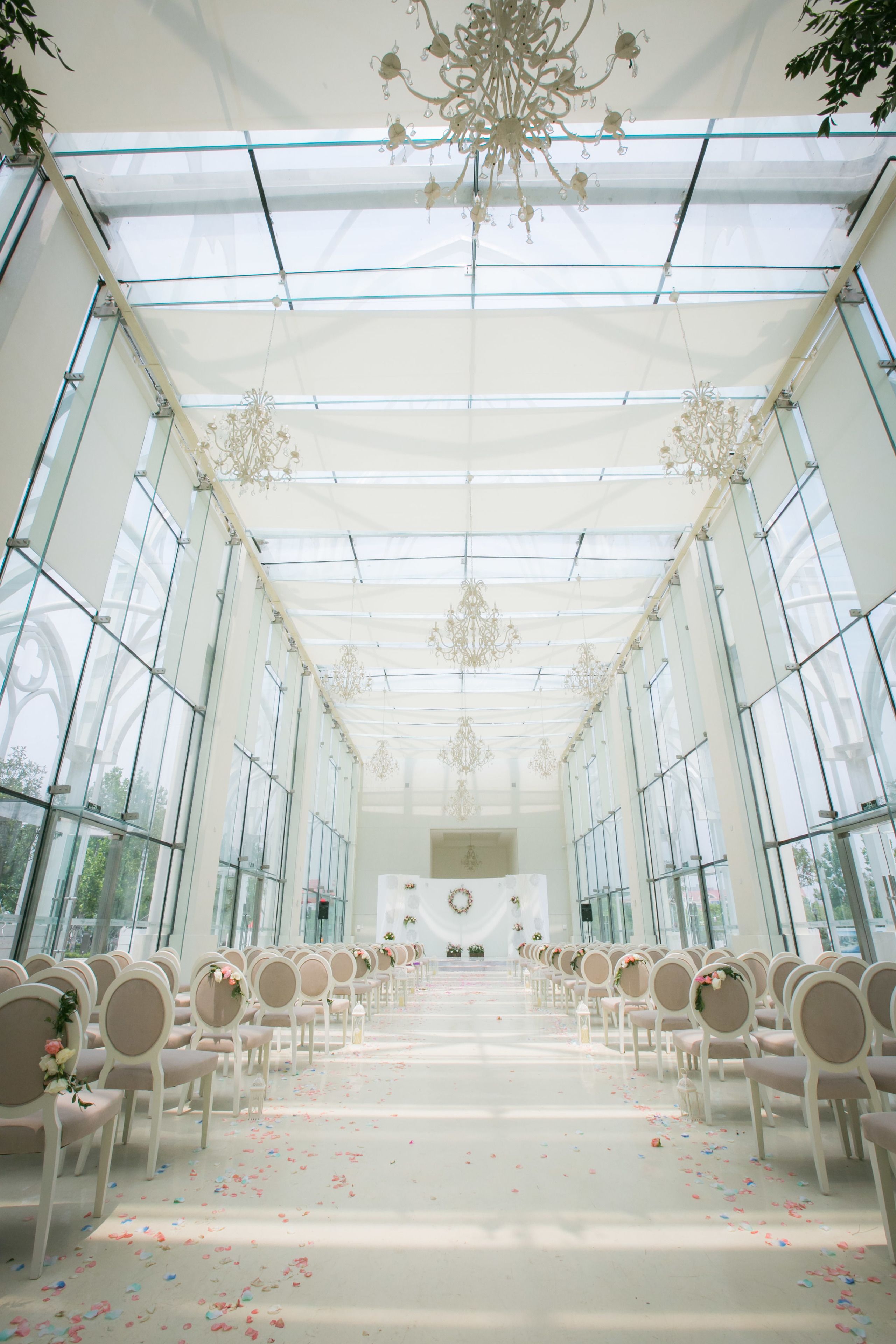 A spacious hall with rows of chairs and a glass ceiling.