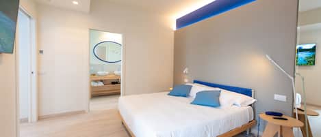 A modern bedroom with a wooden bed, a small bedside table, and a mirror on the wall.