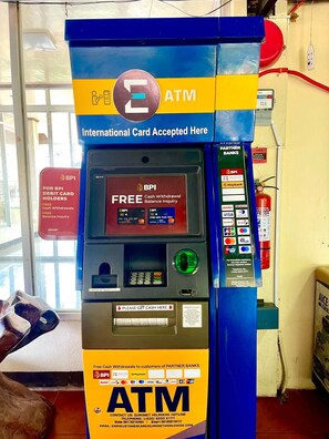 An ATM machine with international card acceptance, free cash withdrawals, and balance inquiries for partner banks. - Panglao Kalikasan Dive Resort (Panglao)