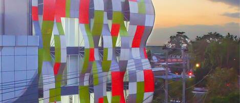 A hotel with a colorful, modern facade and a sign that reads "fiz hotel".