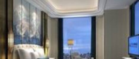 A modern hotel room with a large bed, a television, and a city view.