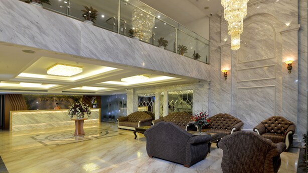 A spacious lobby with a marble reception desk, plush seating, and a grand chandelier. - London Hanoi Hotel (Hanoi)
