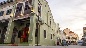 A historic building with a traditional architectural style, featuring a prominent entrance with a red awning and a sign indicating it is a hotel. - D'Nice Heritage House (George Town)