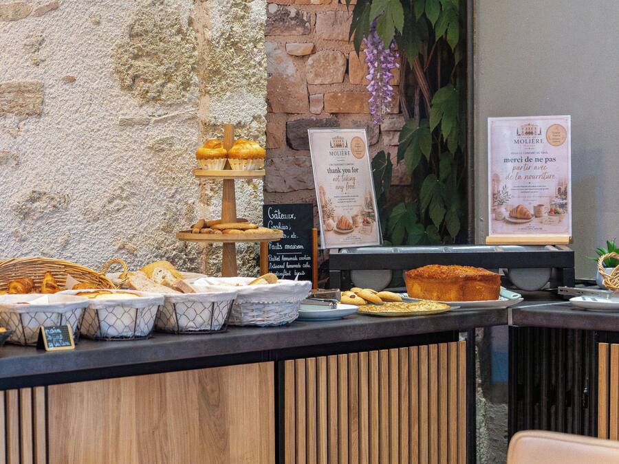 A bakery counter with various baked goods and bread.