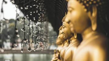 Golden statues with hanging lights.