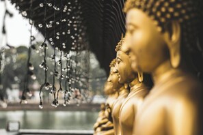 Golden statues with hanging lights.
