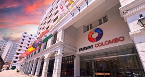 A building with the sign "Fairway Colombo" and multiple flags, including the UK and India flags. - Fairway Colombo - Sri Lanka's First Hotel With Robot Technology (Colombo)