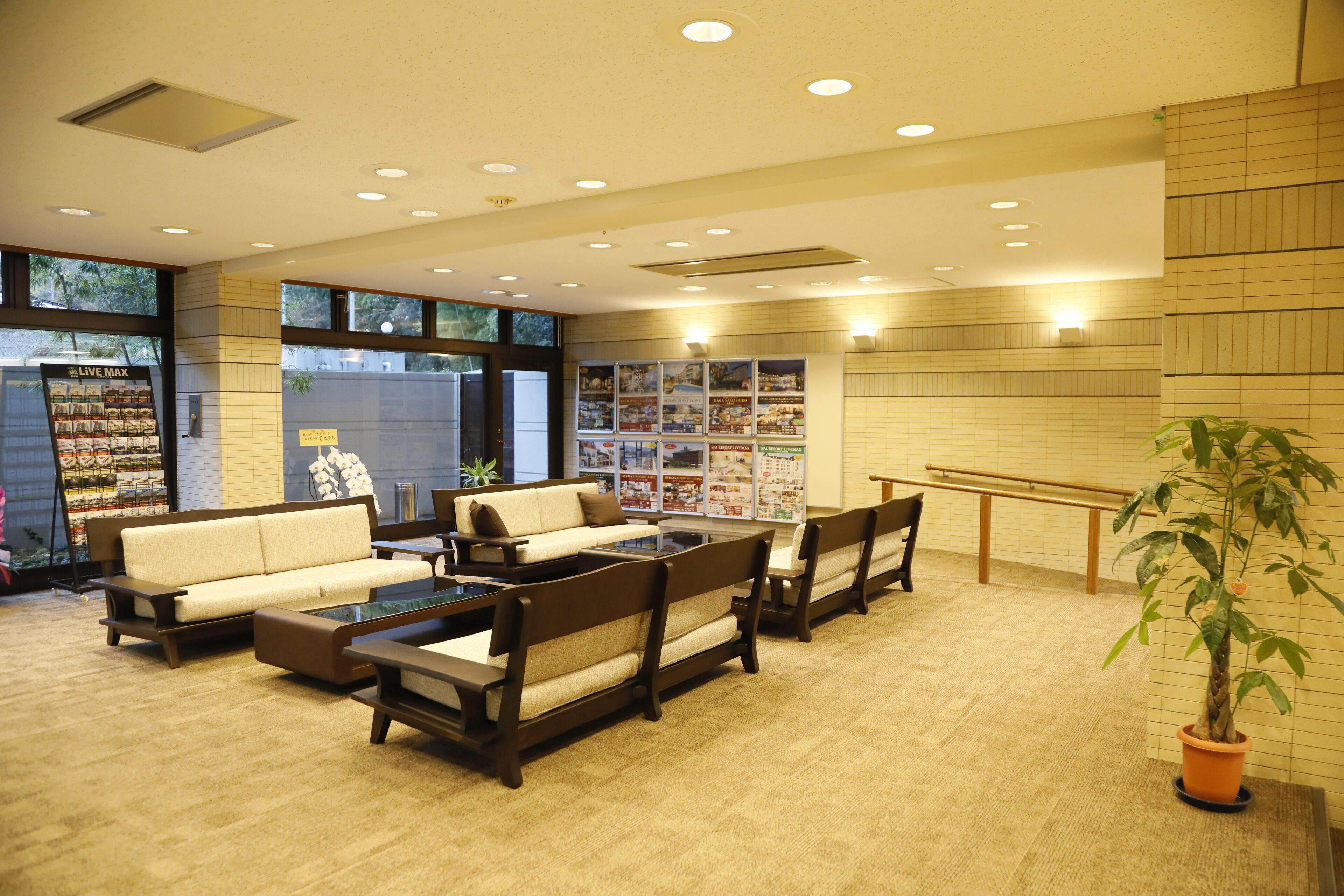 A lobby with seating, a plant, and a display of local products.
