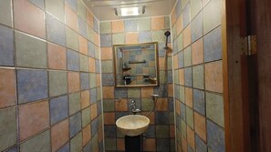A small bathroom with a sink, mirror, and shower. - Gangneongjeon Hanok Stay (Jeonju)