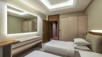A modern hotel room with a large mirror, a wooden vanity, two beds, and a wardrobe.
