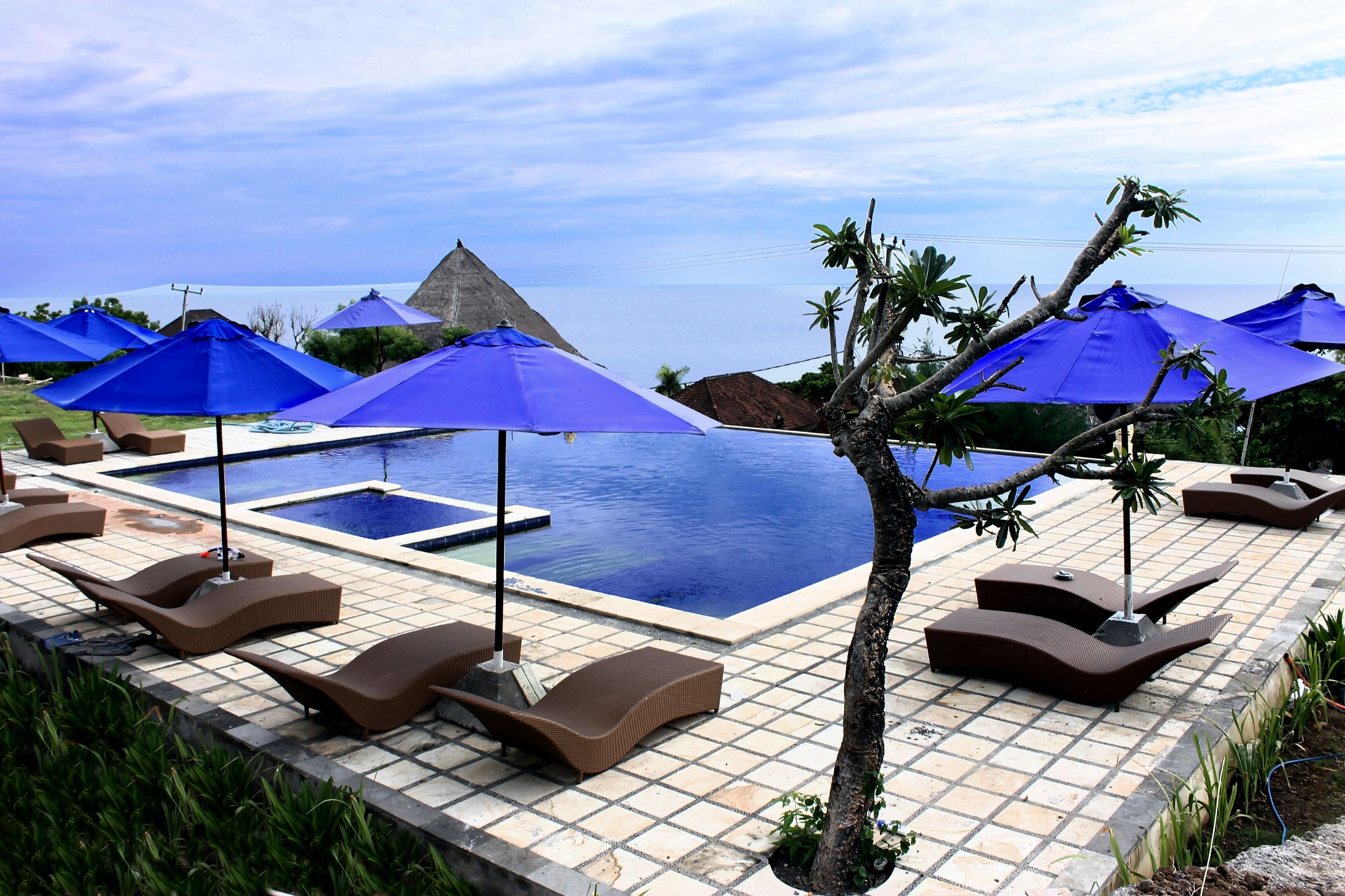 outdoor pool, an infinity pool, pool loungers