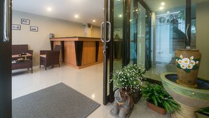 A reception area with a counter, seating, and a decorative elephant statue.