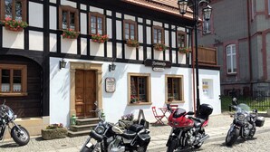 A traditional half-timbered building with a sign indicating a restaurant.