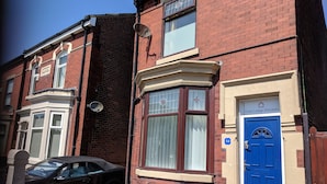 A red brick building with a blue door labeled "Fern Lodge Preston." - Fern Lodge (Preston)