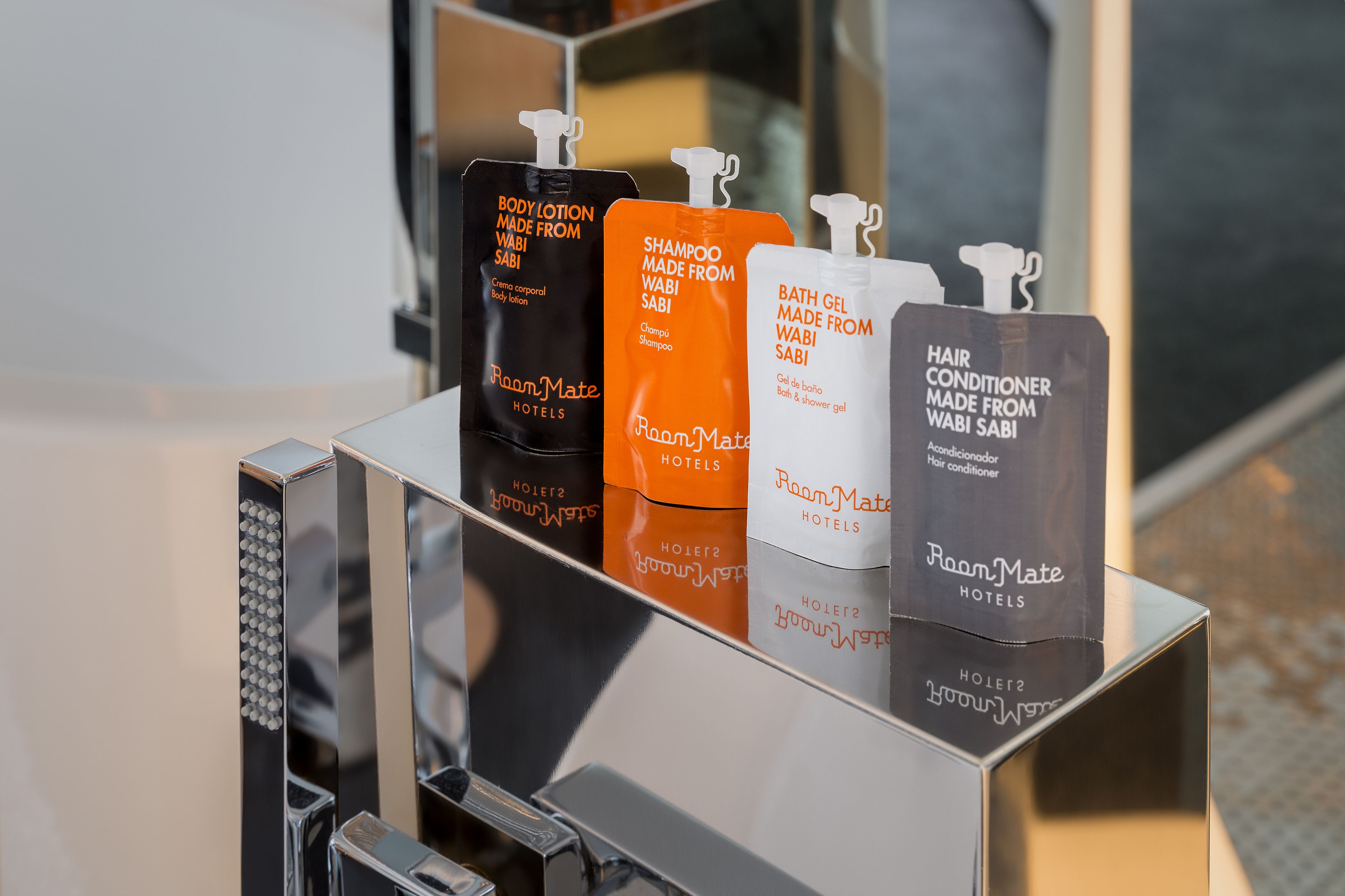 designer toiletries, hair dryer, towels, soap