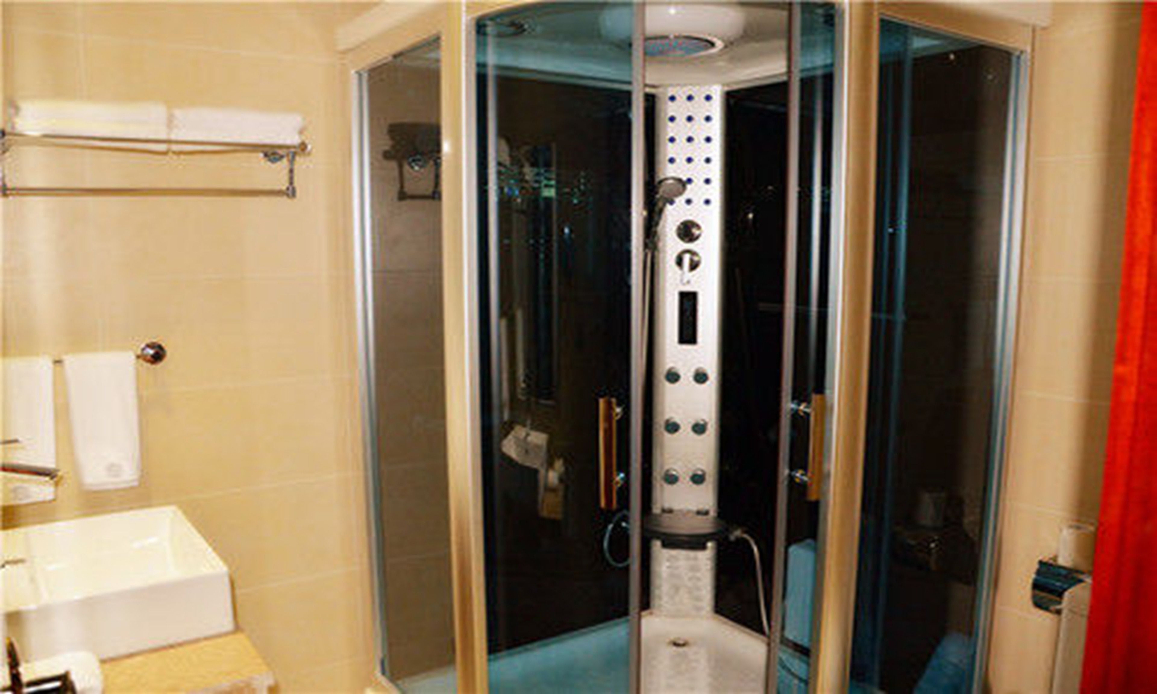 deluxe king room | bathroom | shower, free toiletries, hair dryer, slippers