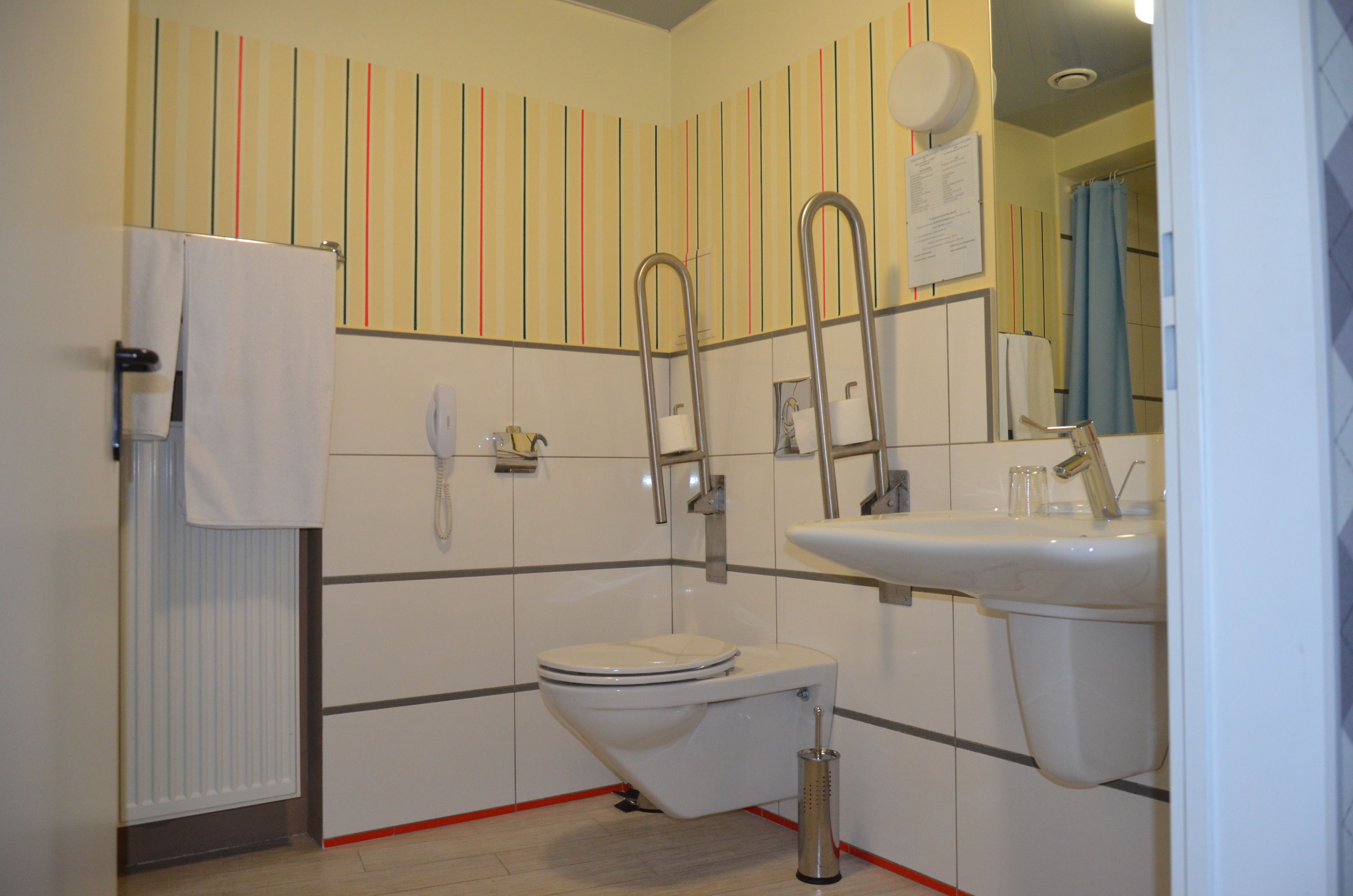 A bathroom with a toilet, bidet, and sink.