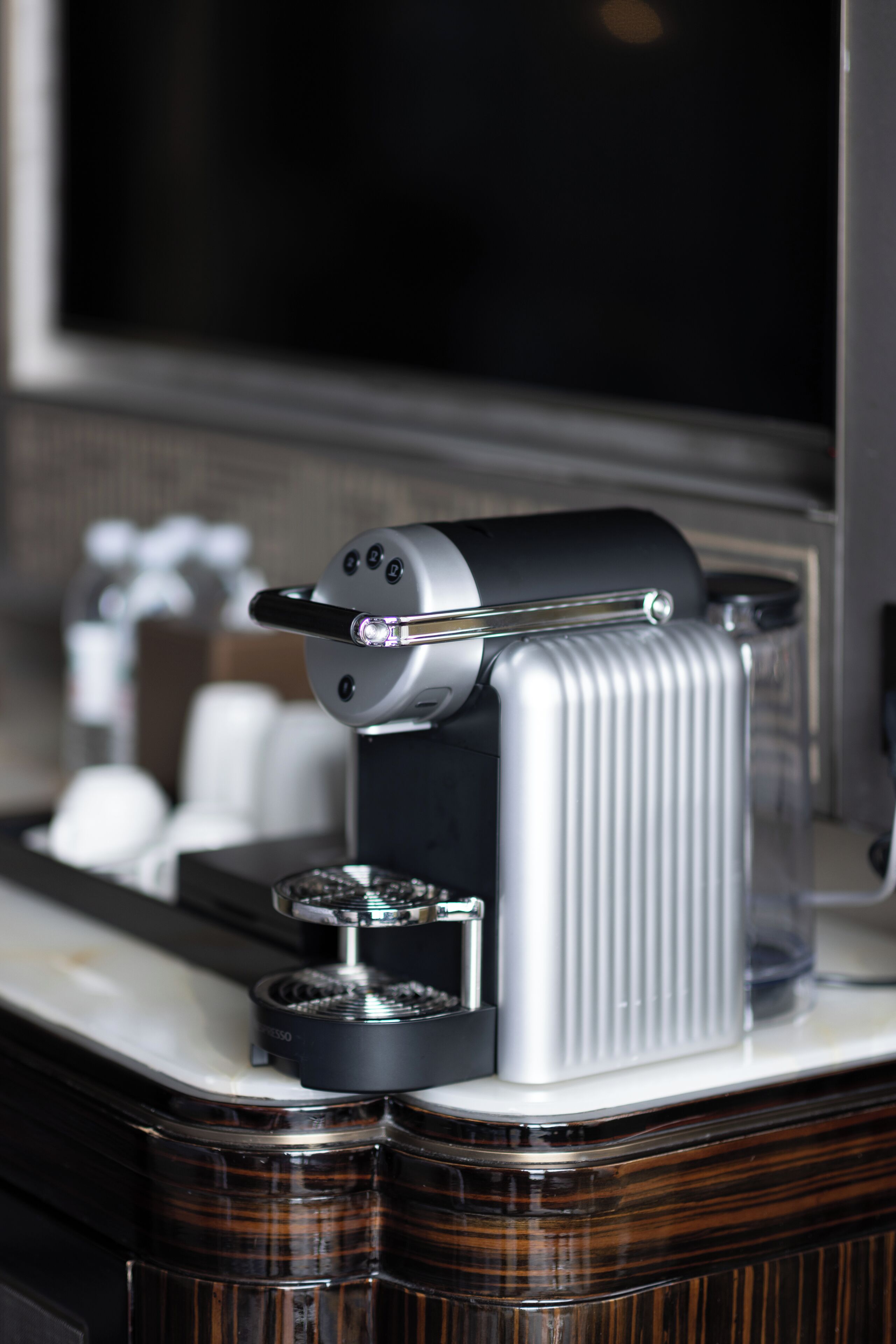A coffee machine on a counter with a blurred background.