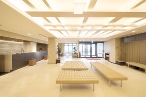 A spacious lobby with a reception desk, seating areas, and large windows allowing natural light. - Richmond Hotel Higashi Osaka (Higashi-osaka)