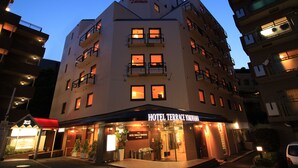 A multi-story hotel with a sign reading "HOTEL TERRACE YOKOHAMA".