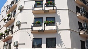 A multi-story hotel with balconies, air conditioning units, and a sign reading "HOTEL TERRACE YOKOHAMA".