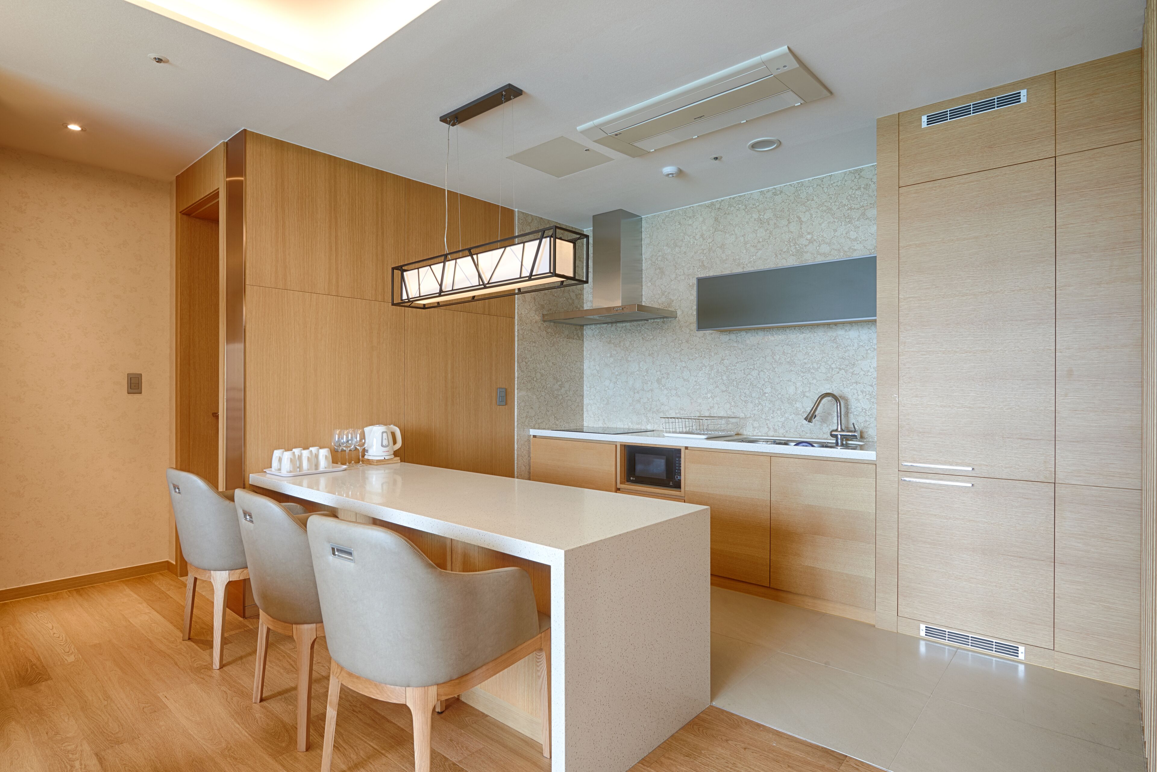 A modern kitchen with a central island, built-in appliances, and a minimalist design.