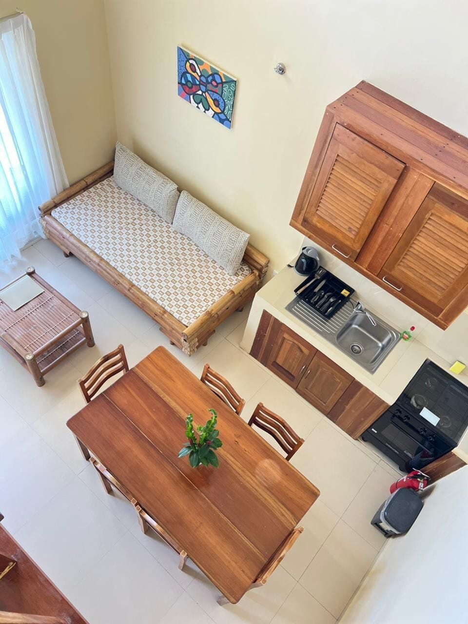 A compact living space with a sofa, dining table, and kitchen area.