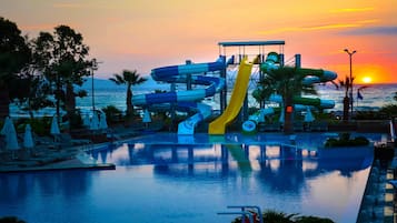 Enjoy thrilling water slides and a pool area surrounded by lounge chairs and umbrellas.