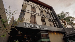 The exterior of the Aliria Hotel with a modern architectural design, featuring a prominent entrance and a signboard. - Aliria Bed and Breakfast (Tagbilaran)
