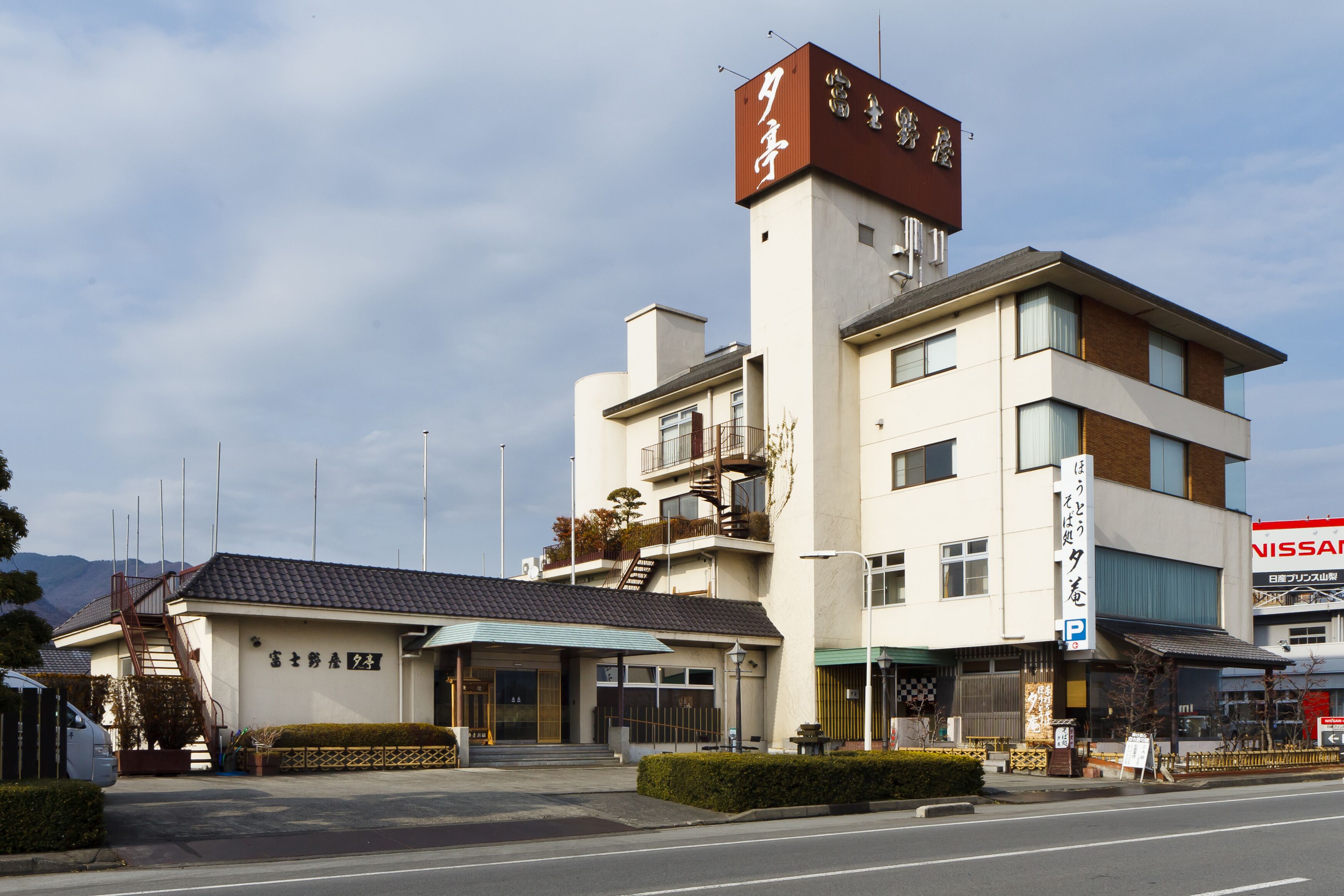 A multi-story building with a prominent sign on the top.