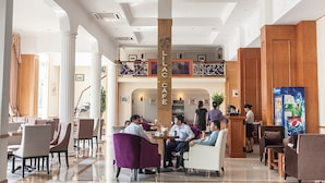 A spacious lobby with a central column labeled "ILAC CAFE," multiple seating areas, and a visible staircase leading to an upper level. - Vietnam Trade Union in Hanoi (Hanoi)