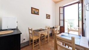 A dining area with wooden furniture, a white appliance, and two framed pictures on the wall. - L'ARANCETO&STILNOVO GUEST HOUSE DI TOKA ALFONS (Florence)