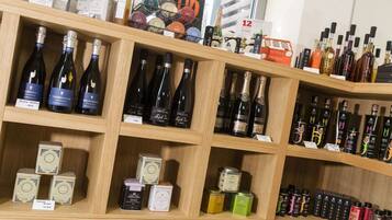 A store with shelves stocked with various bottles of alcohol and toiletries.