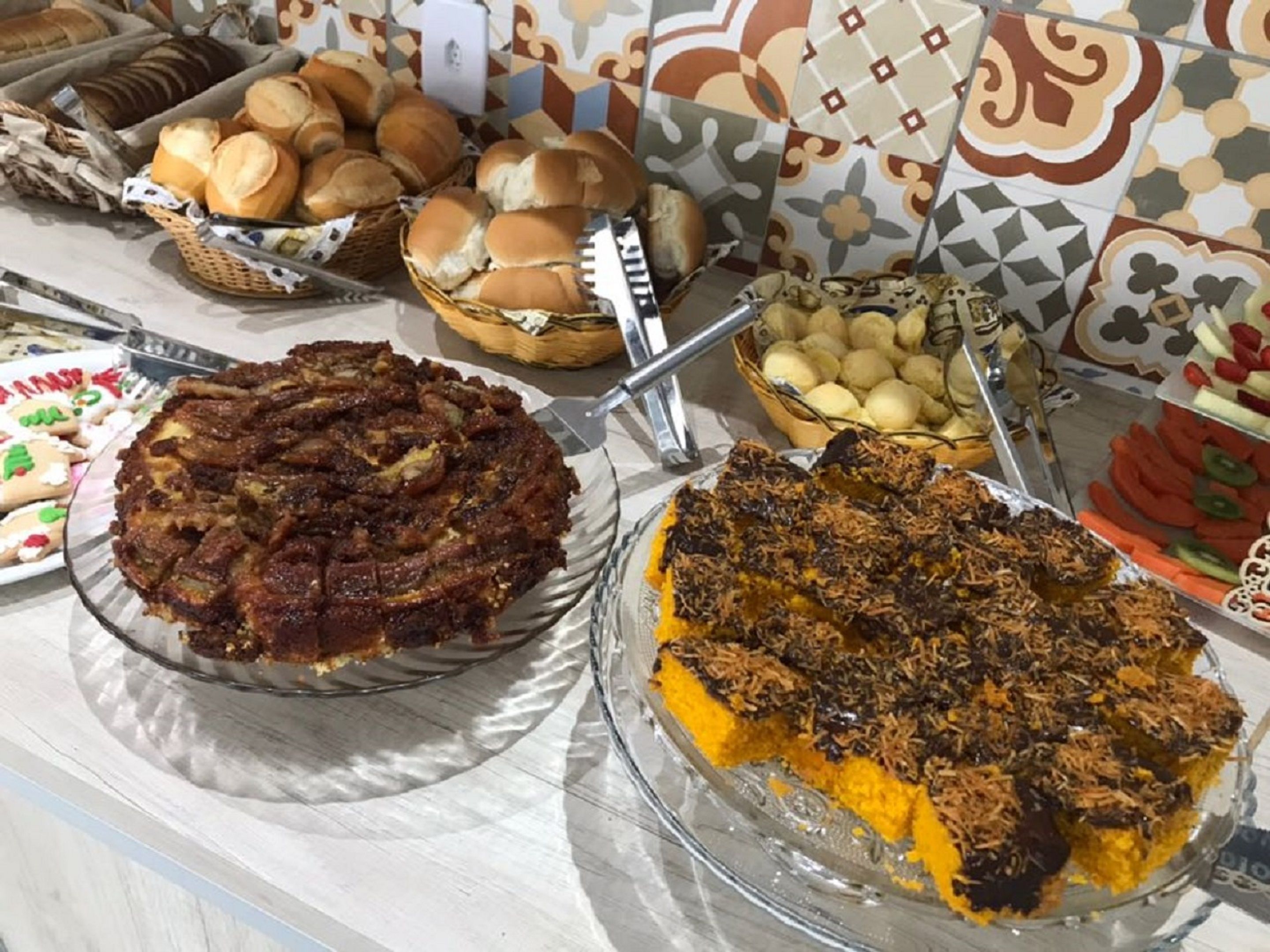 A buffet table with various food items including cakes and pastries.